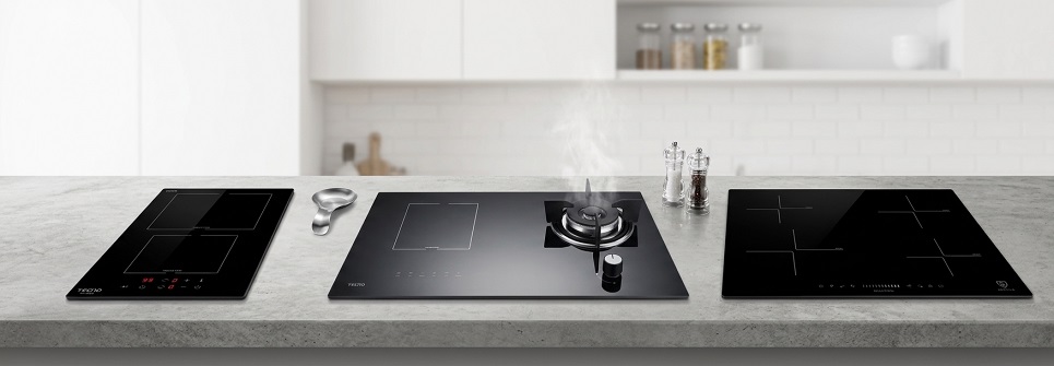A row of induction hobs on a kitchen island